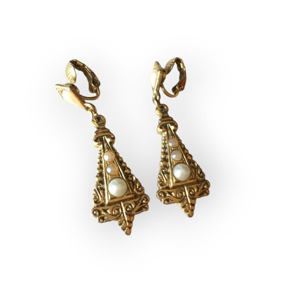 Ornate gold tone and faux pearl accent clip on earrings